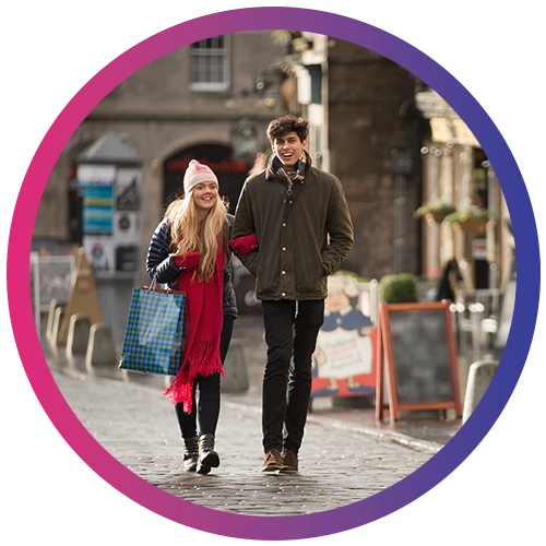 A young couple shop in the Grassmarket in Edinburgh, Scotland