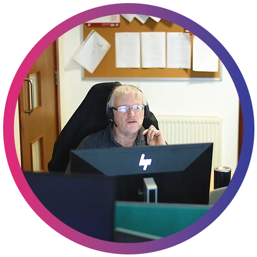 Jera IT team member working on a computer using a VOIP headset