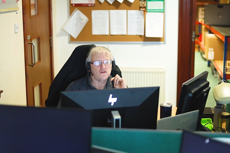 Jera IT team member working on the computer using headset